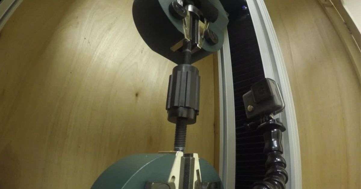 Photograph of a low voltage standoff insulator subjected to tensile forces via Termate testing apparatus